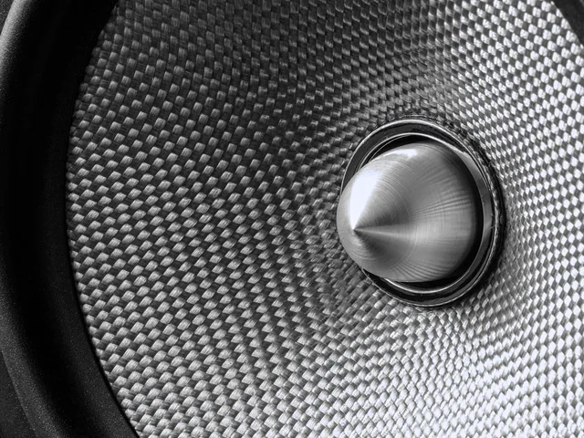 A woven driver face with a machined dome at its centre.