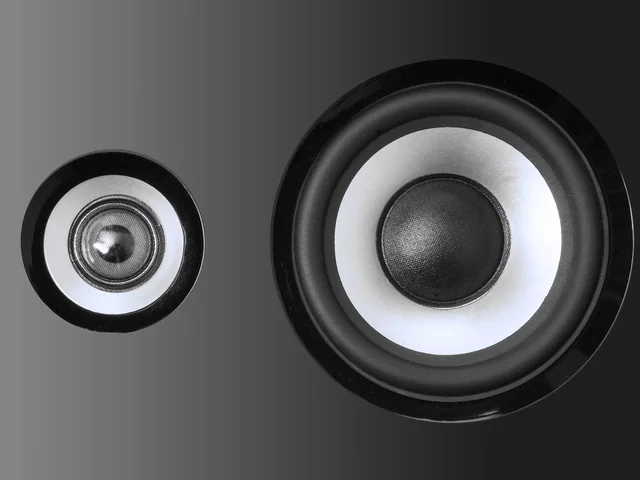 A pair of drive units, the nearer one lit from the left.